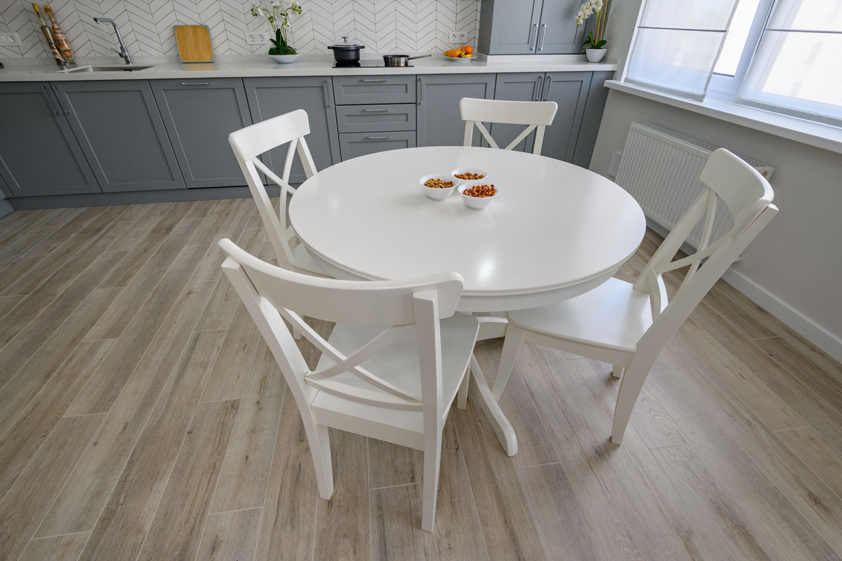 Beautiful dining area with white massive dining table and chairs for four