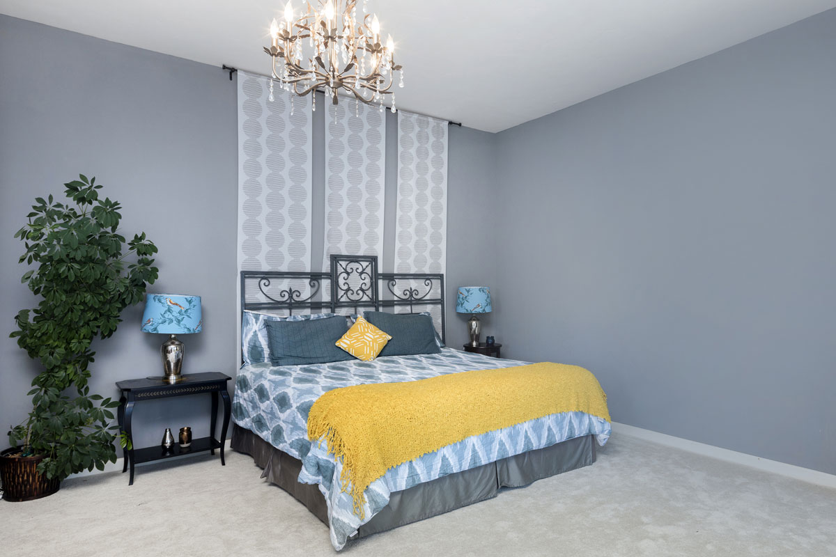 Blue Bedroom with king size bed and chandelier