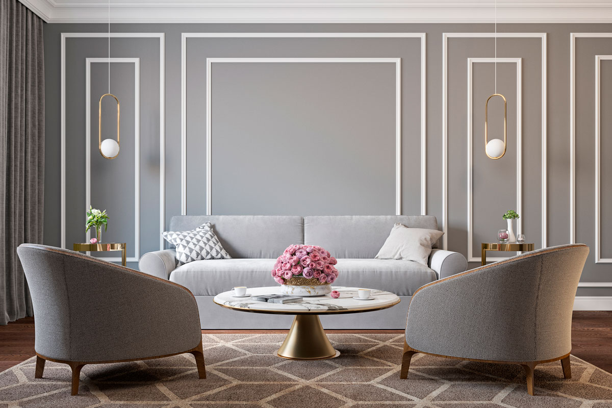 Classic gray interior with armchairs, sofa, coffee table, lamps, flowers and wall moldings