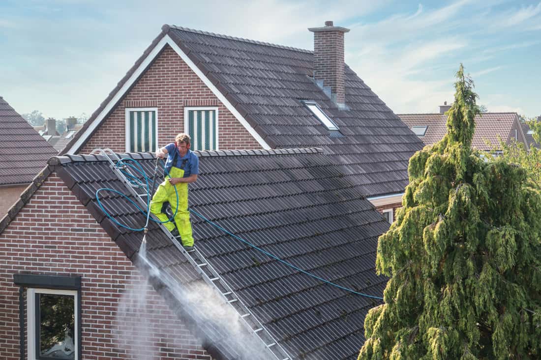 Cleaner with pressure washer at roof house