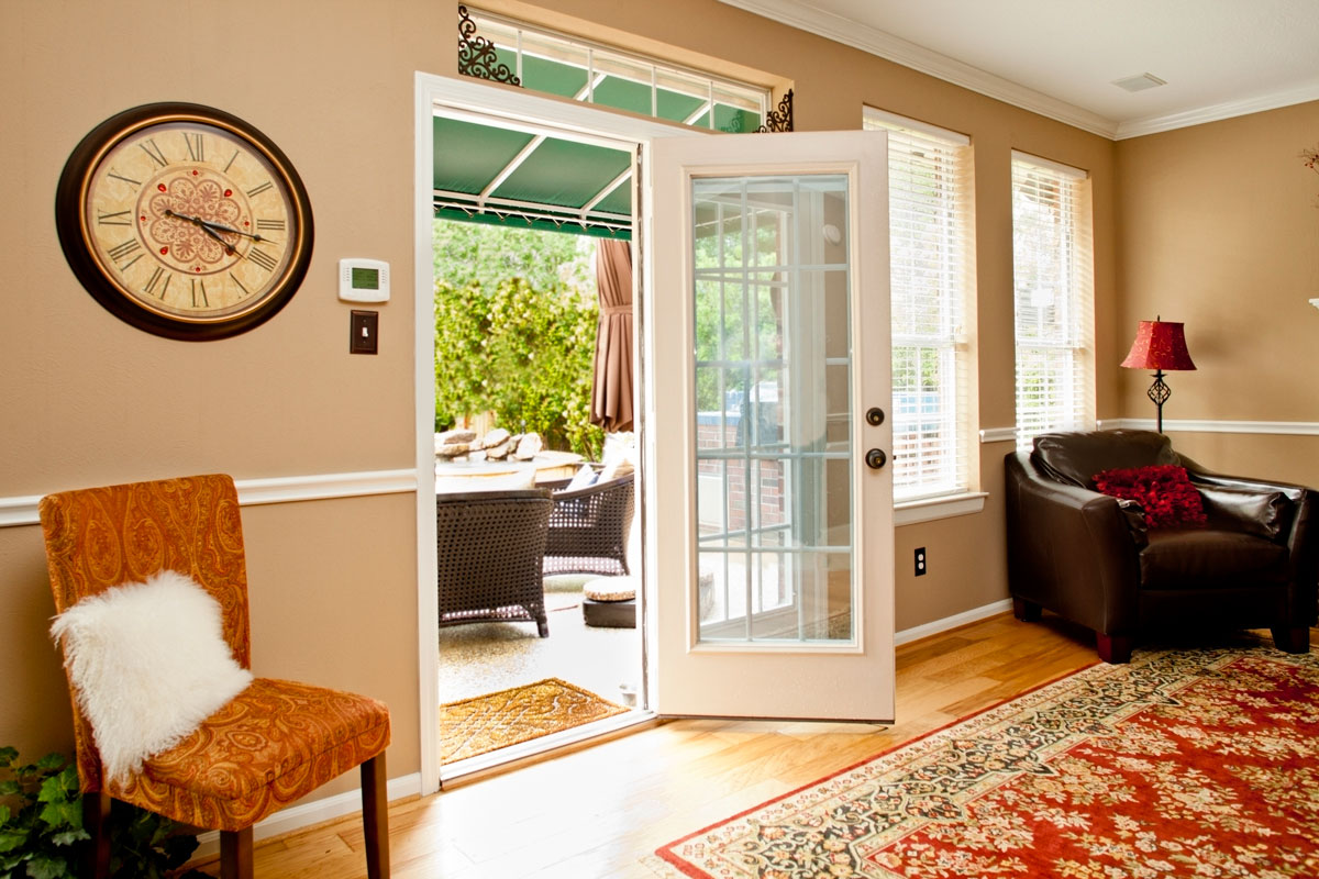 French doors open to back yard and patio area