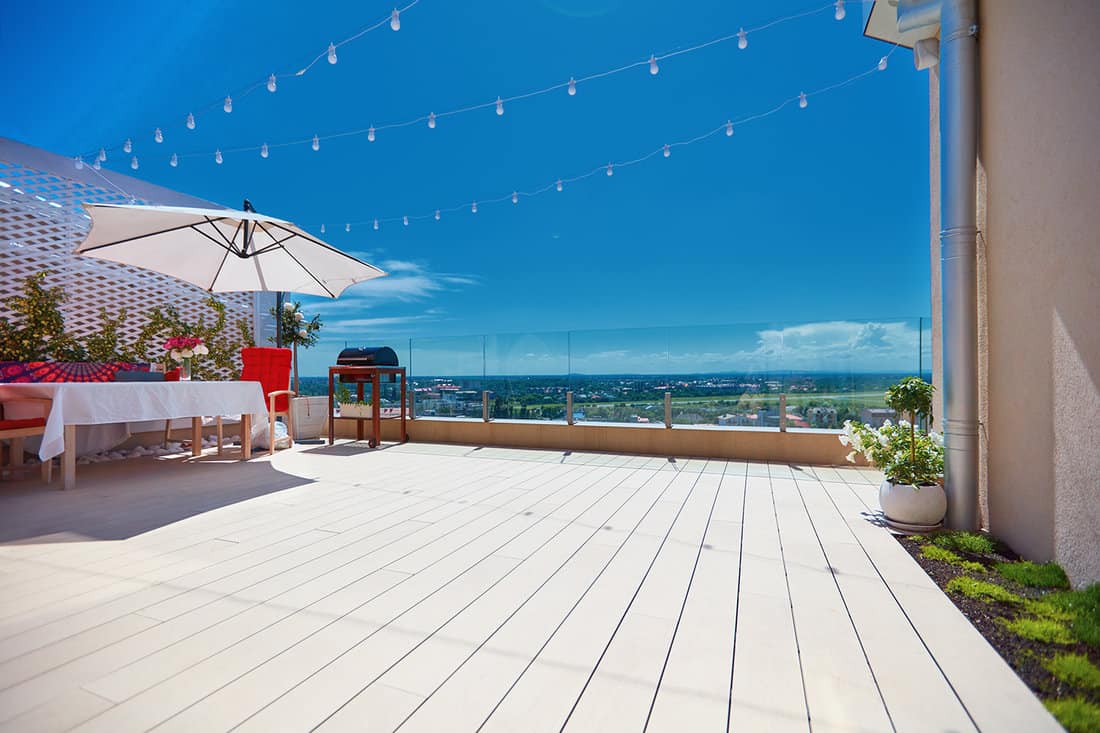 Furnished patio zone, rooftop terrace at warm summer day
