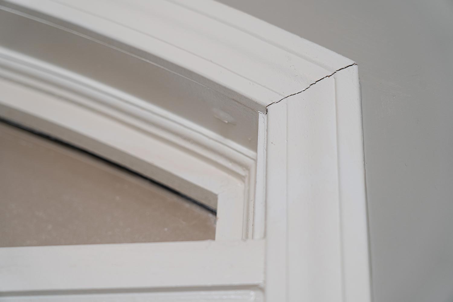 Gaps in trim molding around a door frame create unsightly cracks