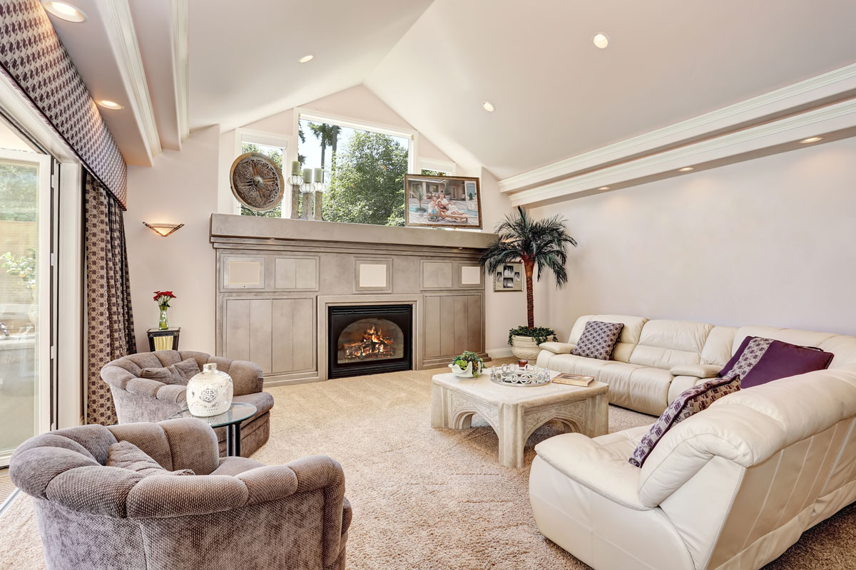 Gorgeous luxury furnished family room interior with vaulted ceiling