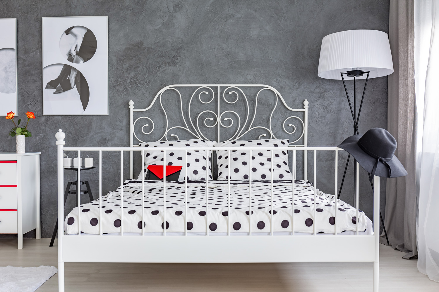 Grey bedroom with large bed with decorative metal headboard