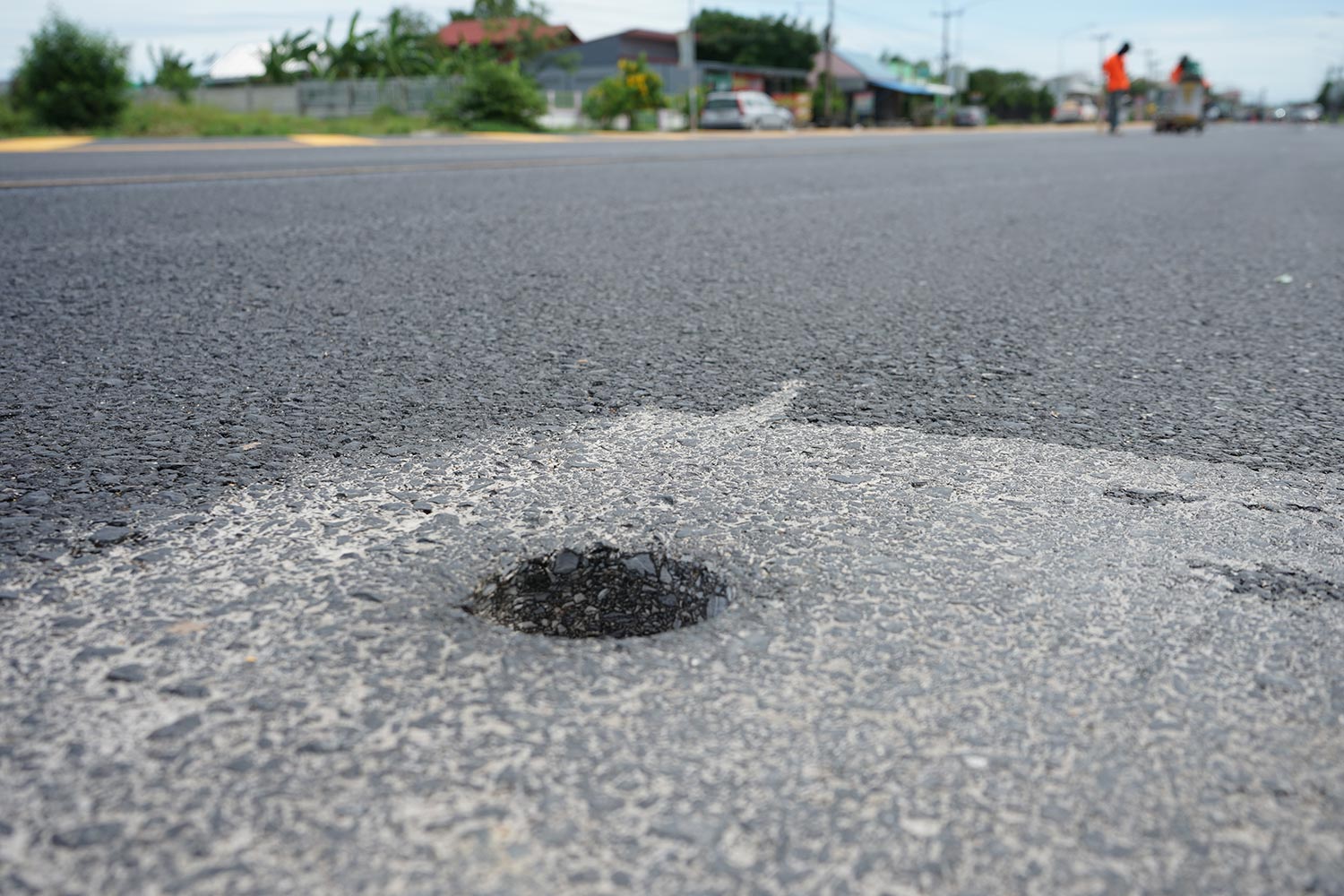 Holes from drilling to measure asphalt road thickness