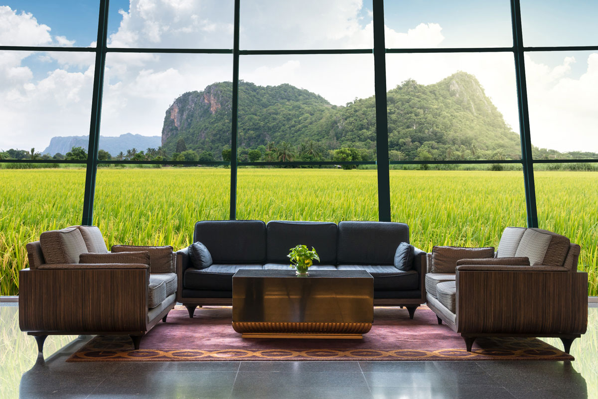 Huge luxurious living room with a huge window proving an amazing view of a gorgeous landscape