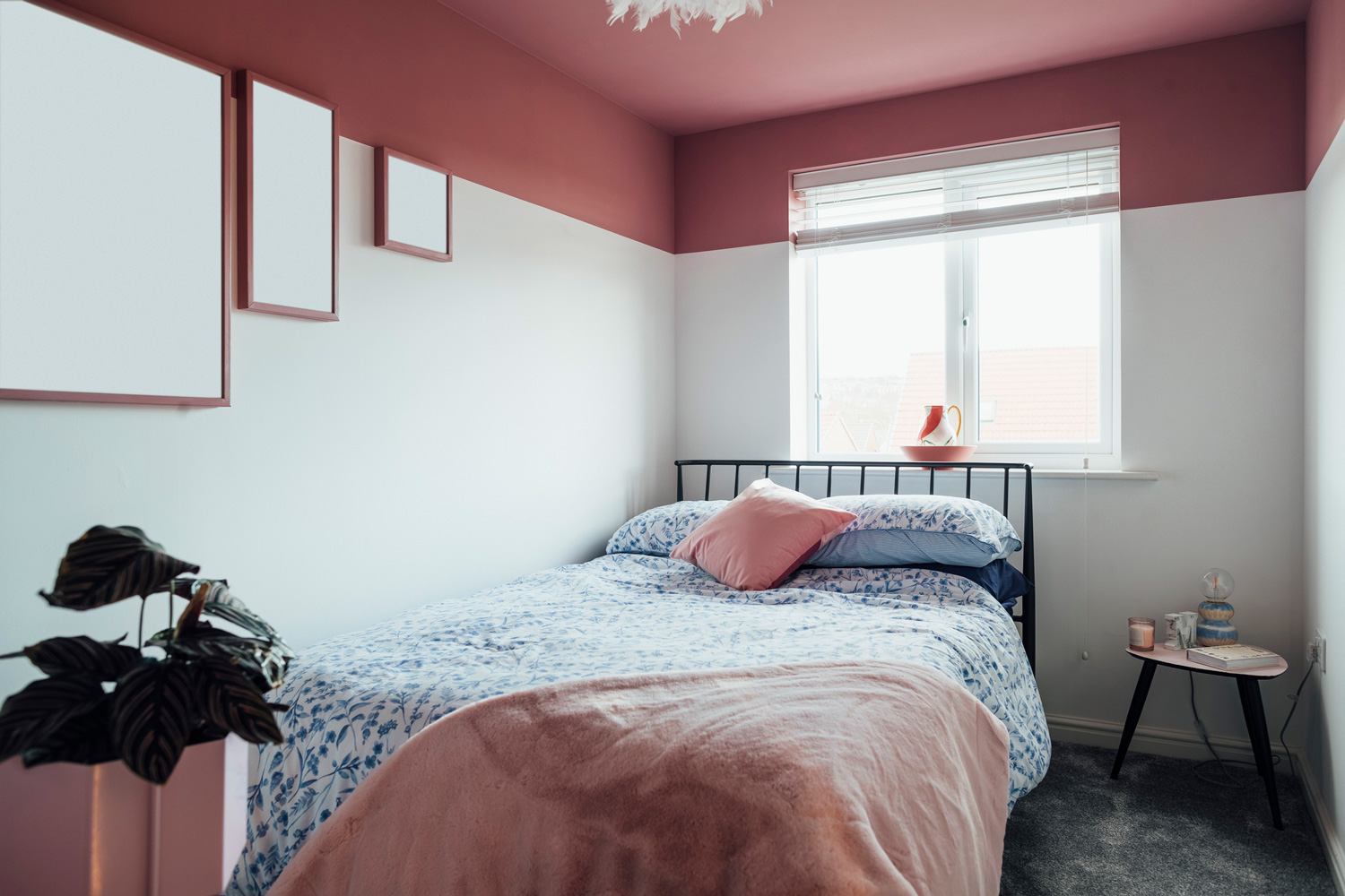 Interior of a feminine bedroom in the Northeast of England. There is a pink ceiling.