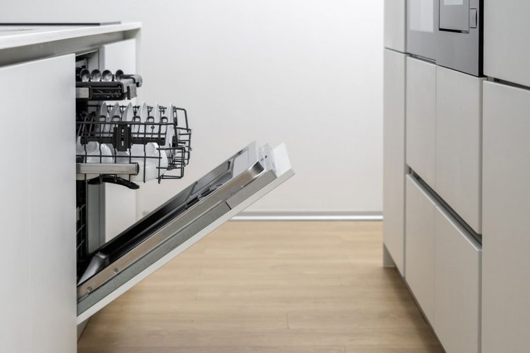 Kitchen with white furniture and built in electrical devices, open dishwasher with basket and clean tableware inside, dishes and crockery laying after being washed by machine, How To Find The Model Number On A Kitchenaid Dishwasher?