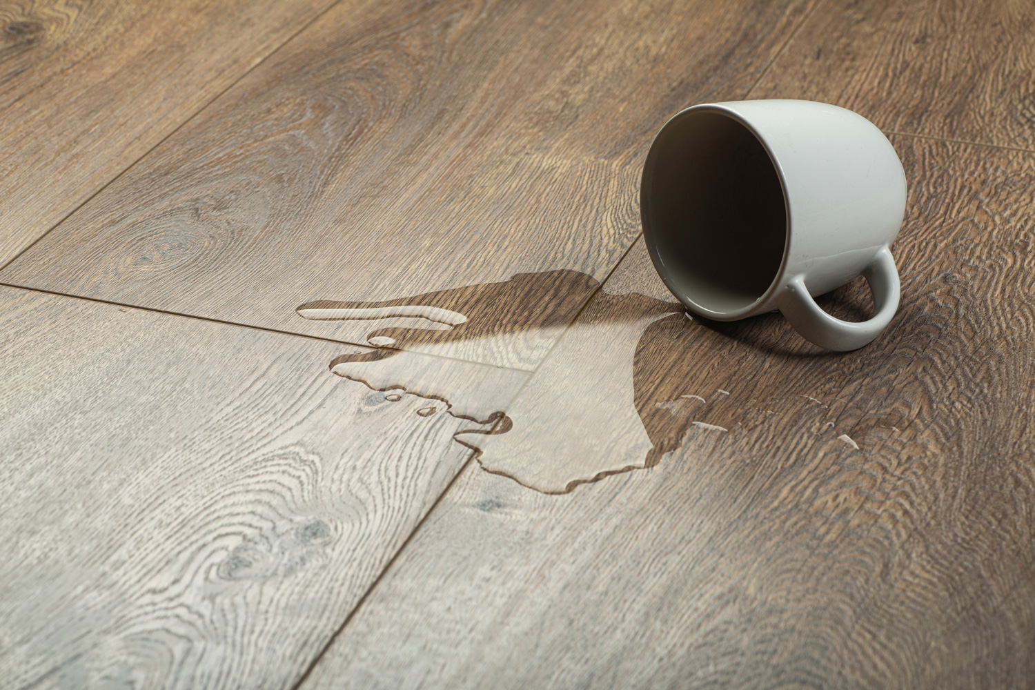 Laminate background.. Wooden laminate and parquet board with spilled water. Moisture protection of a floor