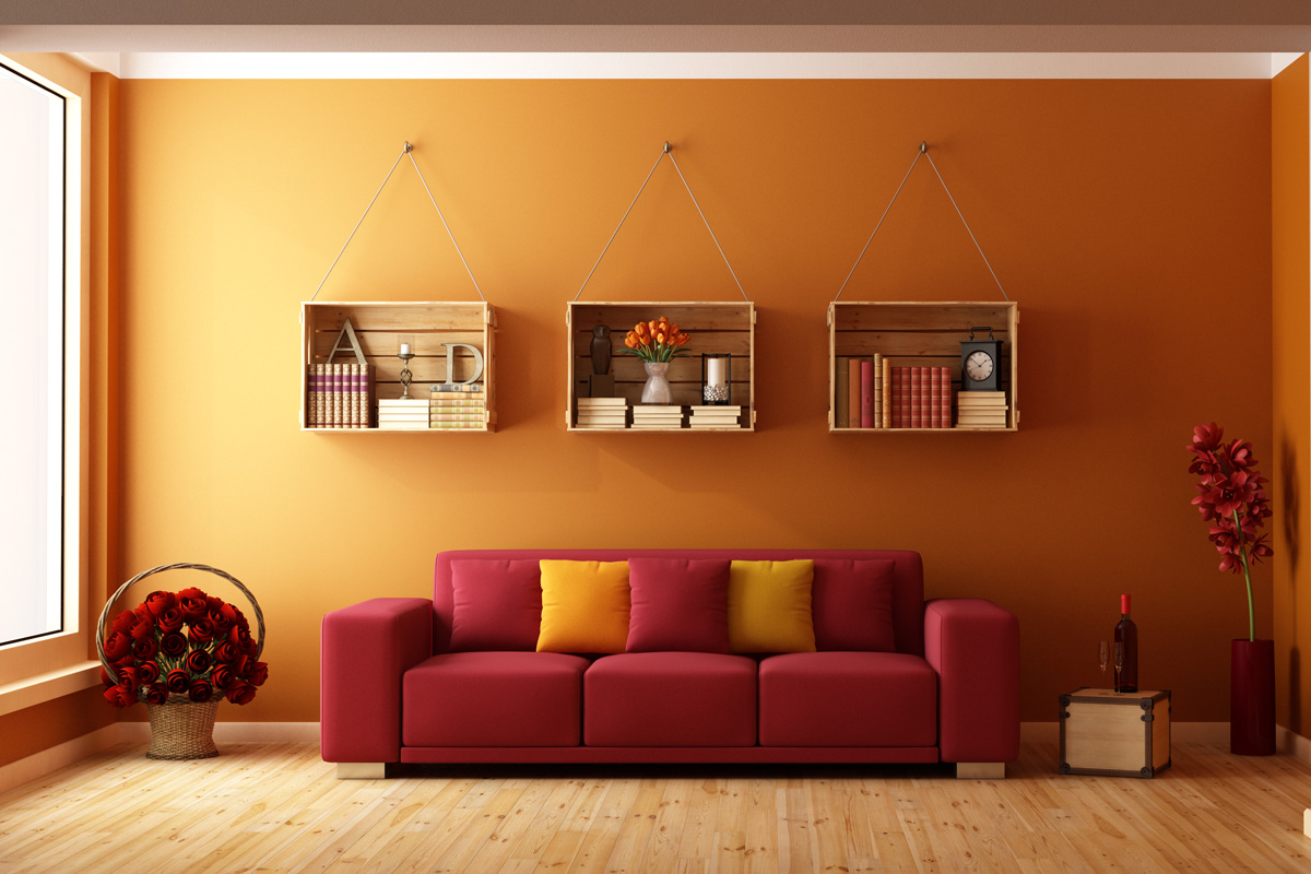 Living room with red sofa and wooden crates used as a bookcase 