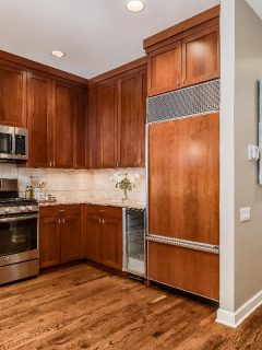 A luxurious kitchen with dark wood cabinets and GE appliances, How To Find The Model Number On A GE Stove