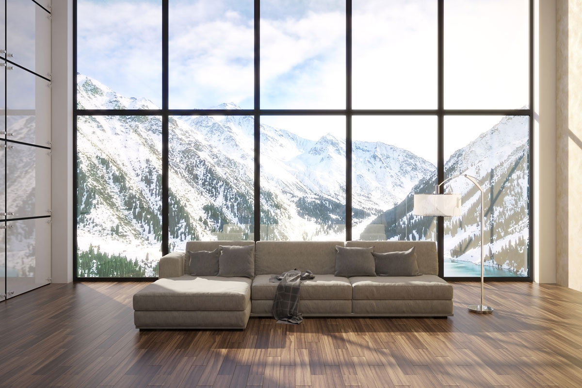 Luxurious living room with a gray sectional sofa and an amazing view of a mountain landscape