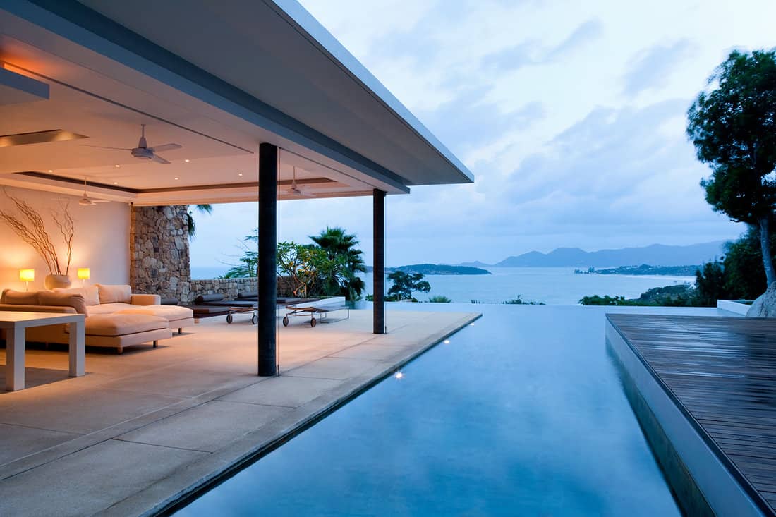 Luxury island villa with infinity pool at sunset