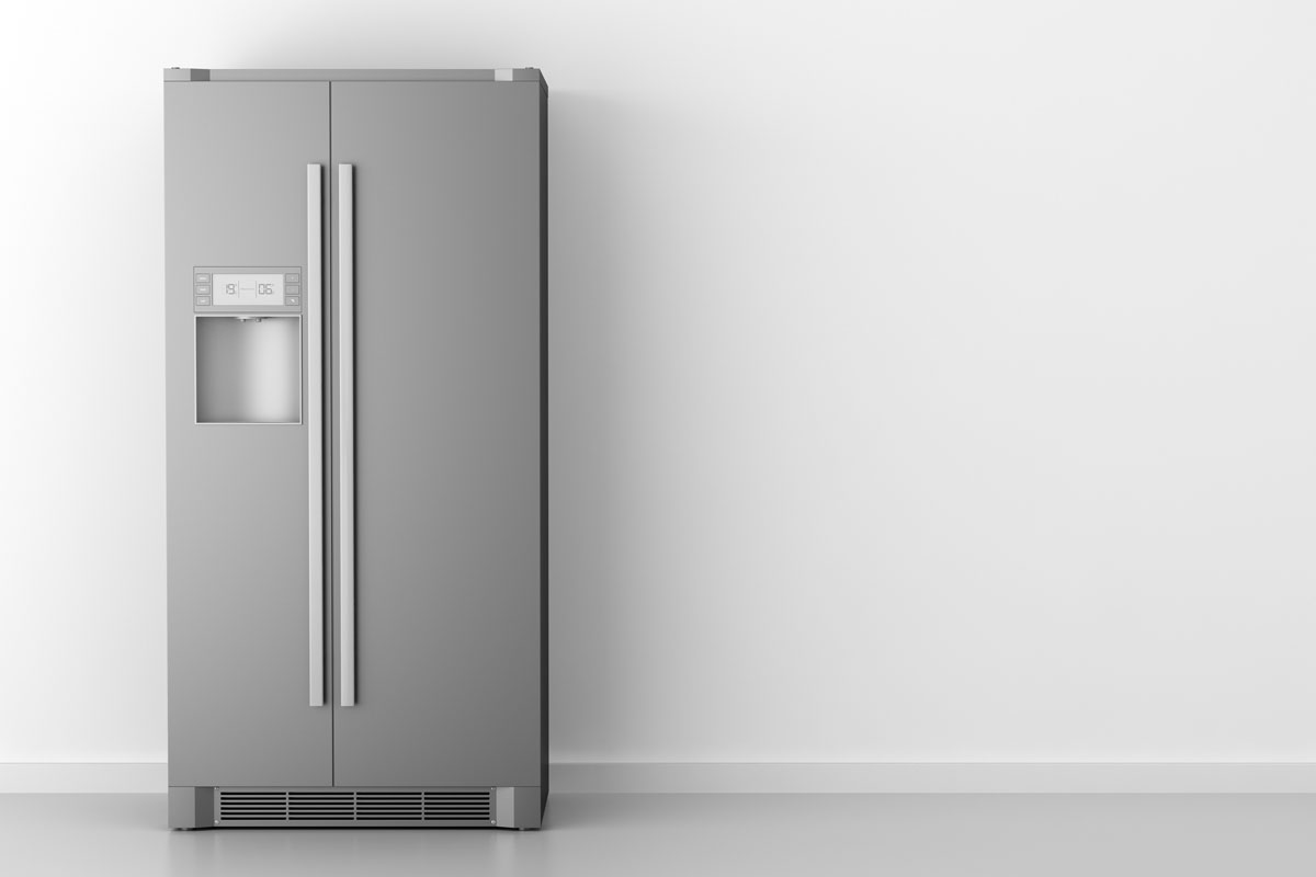 Modern gray fridge on a white wall