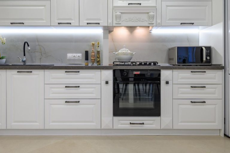 A modern large luxurious white kitchen interior, How Much Space Between Microwave And Stove?