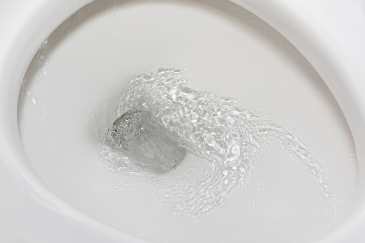 Motion blur of flushing water in toilet bowl