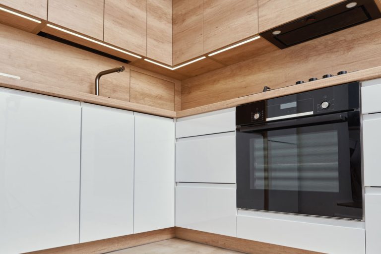New modern kitchen interior, Minimal design with white cupborads, sink electrical oven and gas hob, How Much Space Between Oven And Cabinets?