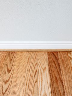 Newly installed red oak floor boards with trim protection for wall, What Paint Colors Go With Oak Trim?