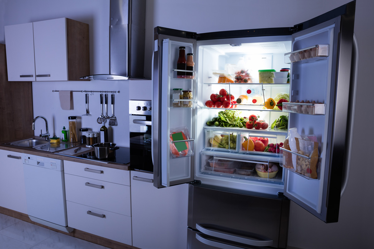 Open Refrigerator Full Of Healthy Items In Modern Kitchen