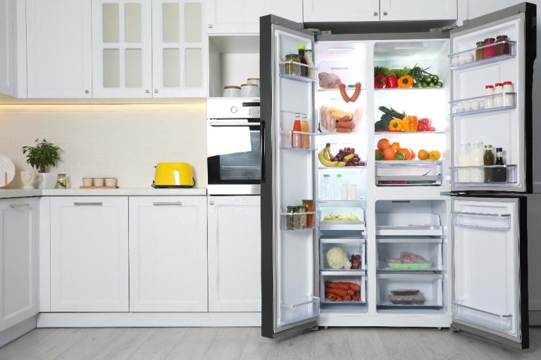 An open refrigerator filled with food in kitchen, GE Profile Refrigerator Not Cooling — What To Do?
