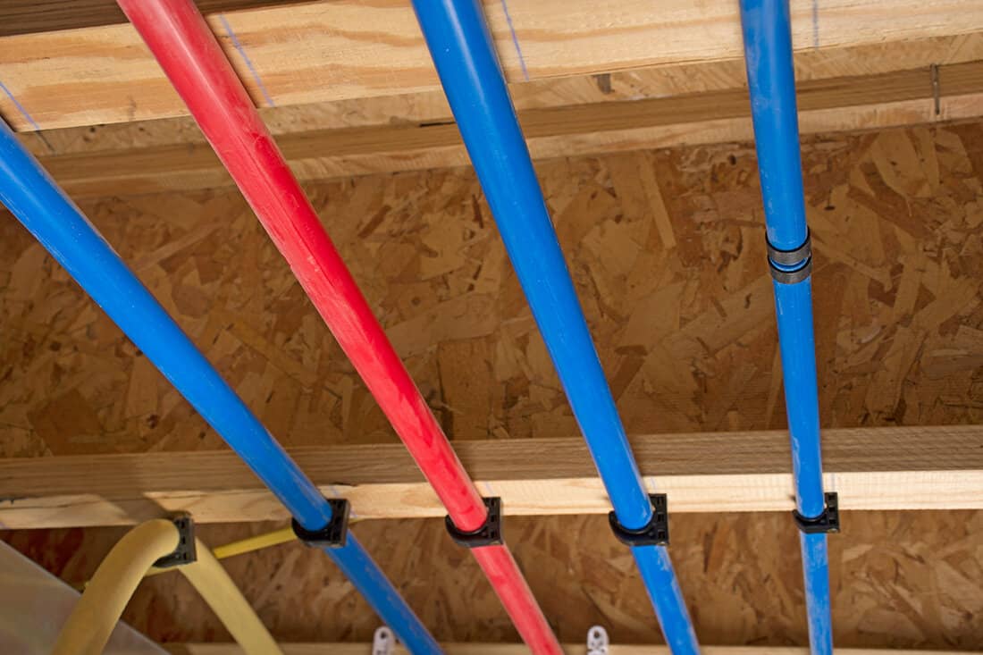 PEX pipes attached to the basement ceiling of a home