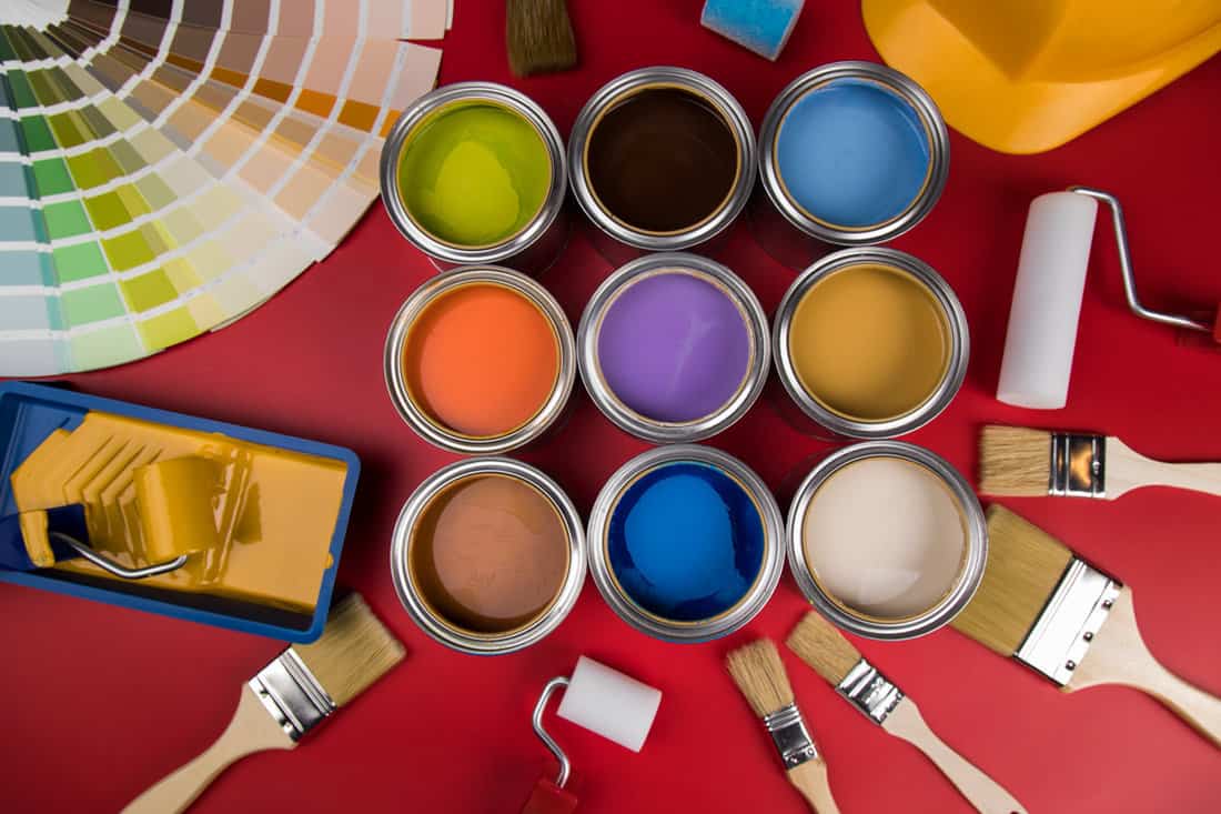 Paint buckets and other painting equipments on the floor
