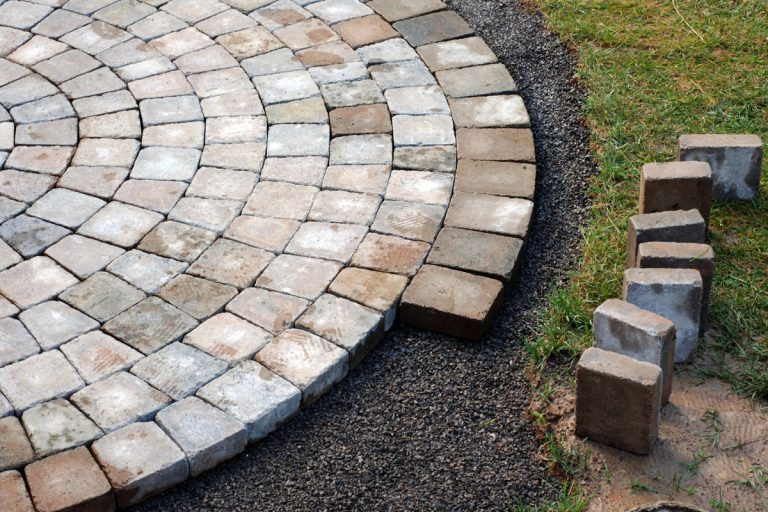 Patio bricks installation in a round form, How Much Space Between Pavers? [By Pavers Size]