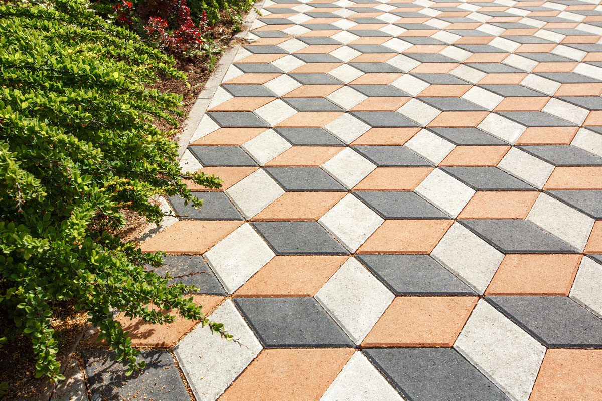 Paving the yard with colored paving tiles in the shape of a diamond