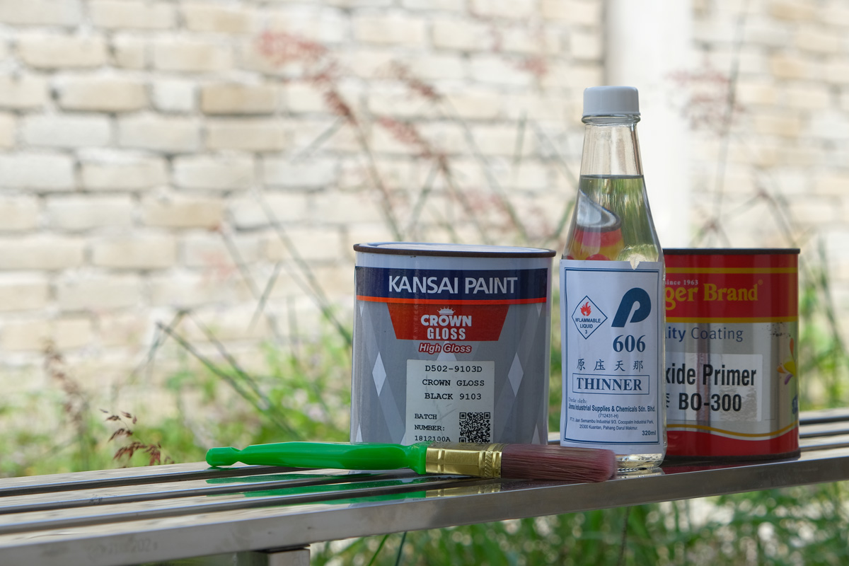  Photo of the paint, primer coating, thinner and paint brush. Concepts of home decoration and painting work.