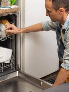 A plumber repairing dishwasher machine, Dishwasher Not Spraying Water: What To Do?