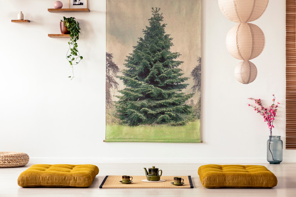 Real photo of a tatami mat with a pot and teacups in a japanese room interior with big tree poster on a wall
