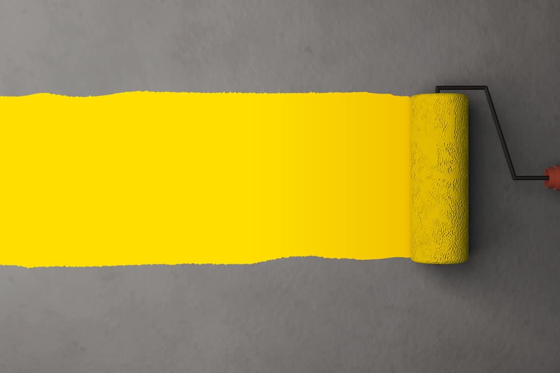 Render Yellow color painting by the roller brush and wall texture background with space for advertising header or details