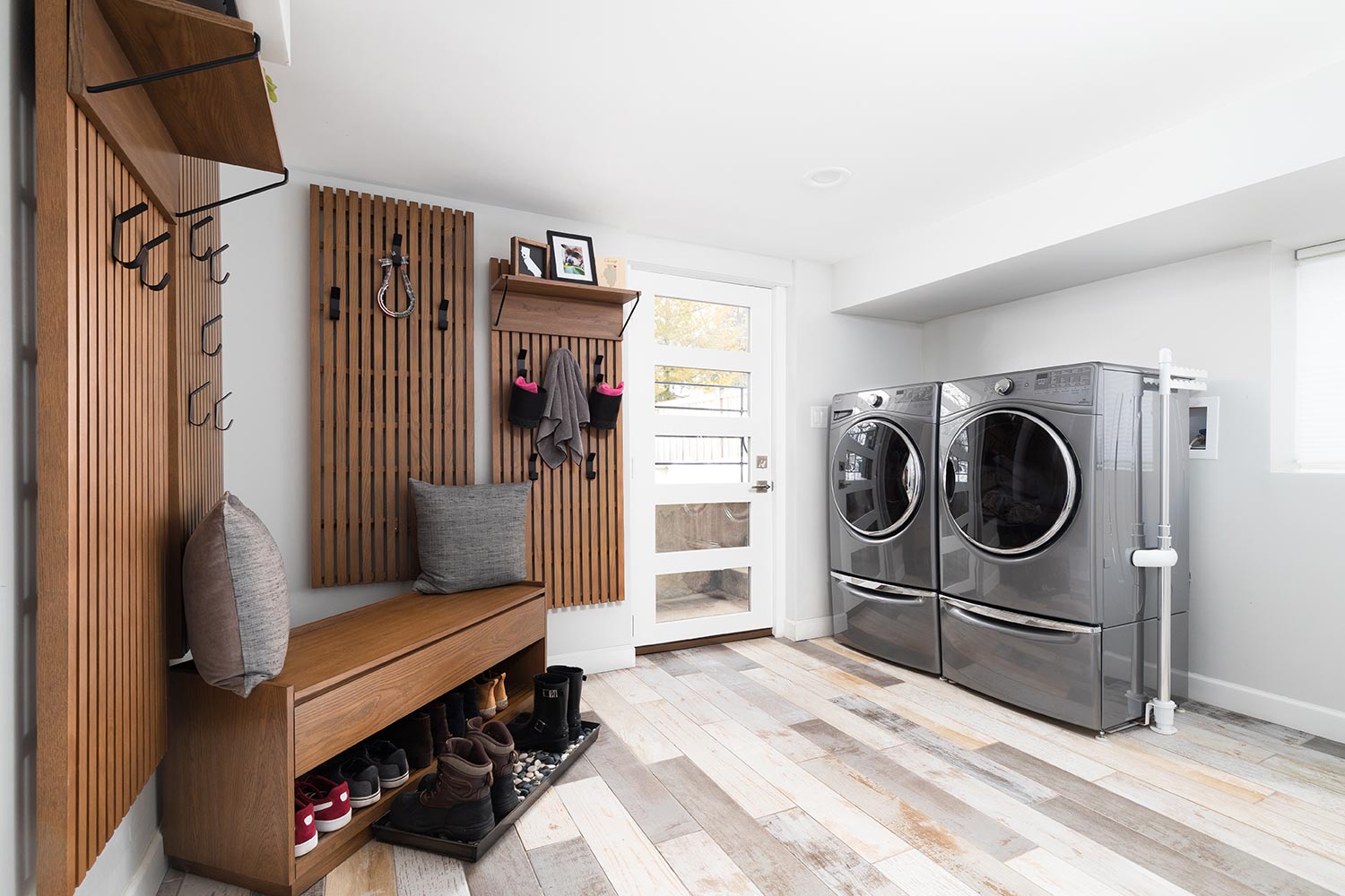 Renovated laundry room with hooks mounted on the wall