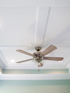 Seamless white ceiling with recessed lighting and a ceiling fan on the middle, How Big And Deep Should A Tray Ceiling Be?