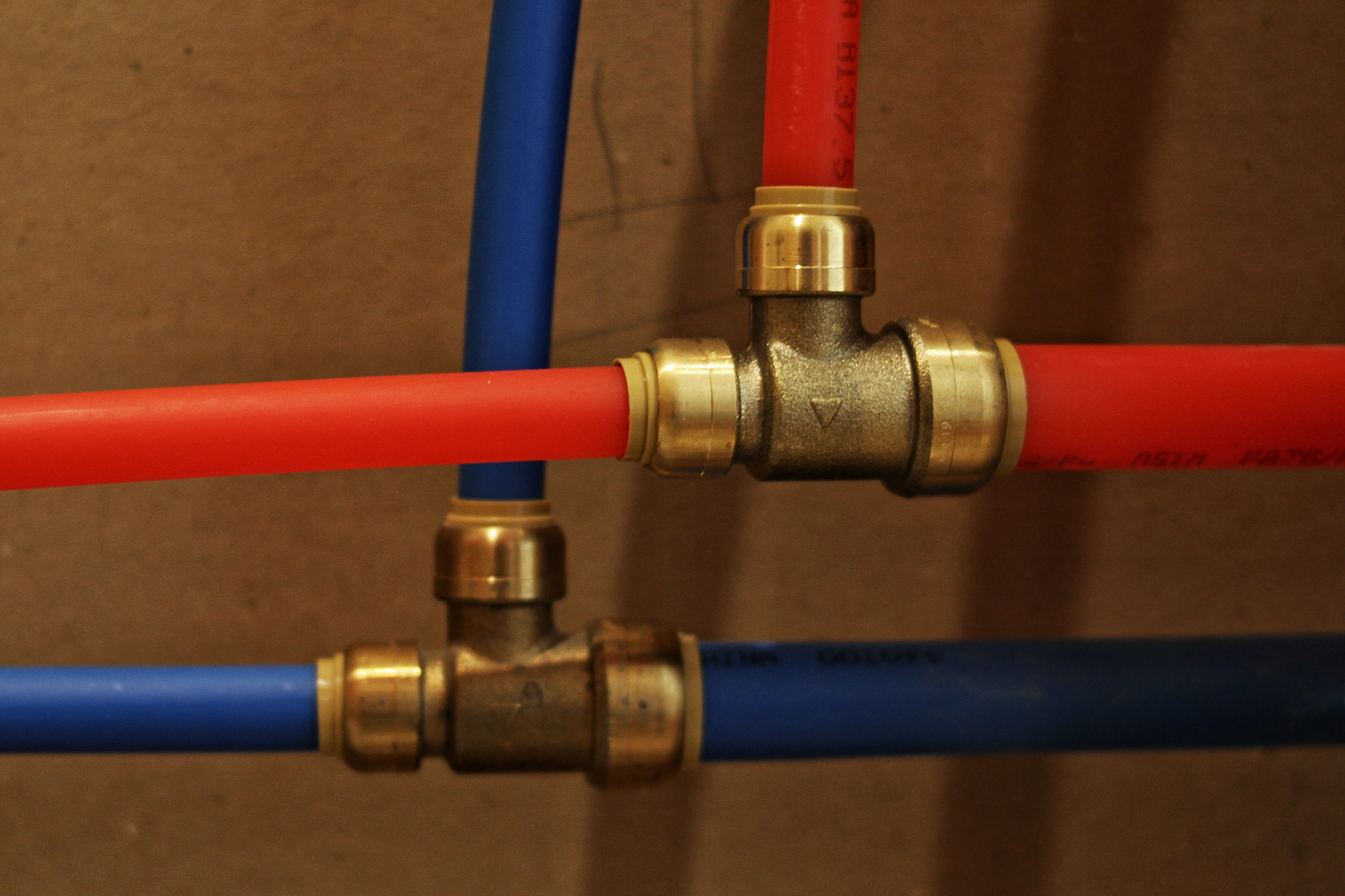 Sharkbite fittings with red and blue PEX pipe.