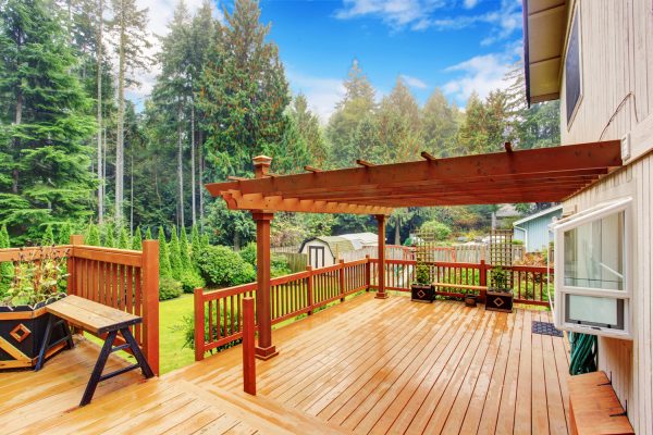 Spacious wooden deck with benches and attached pergola - How Long Does It Take To Refinish A Deck
