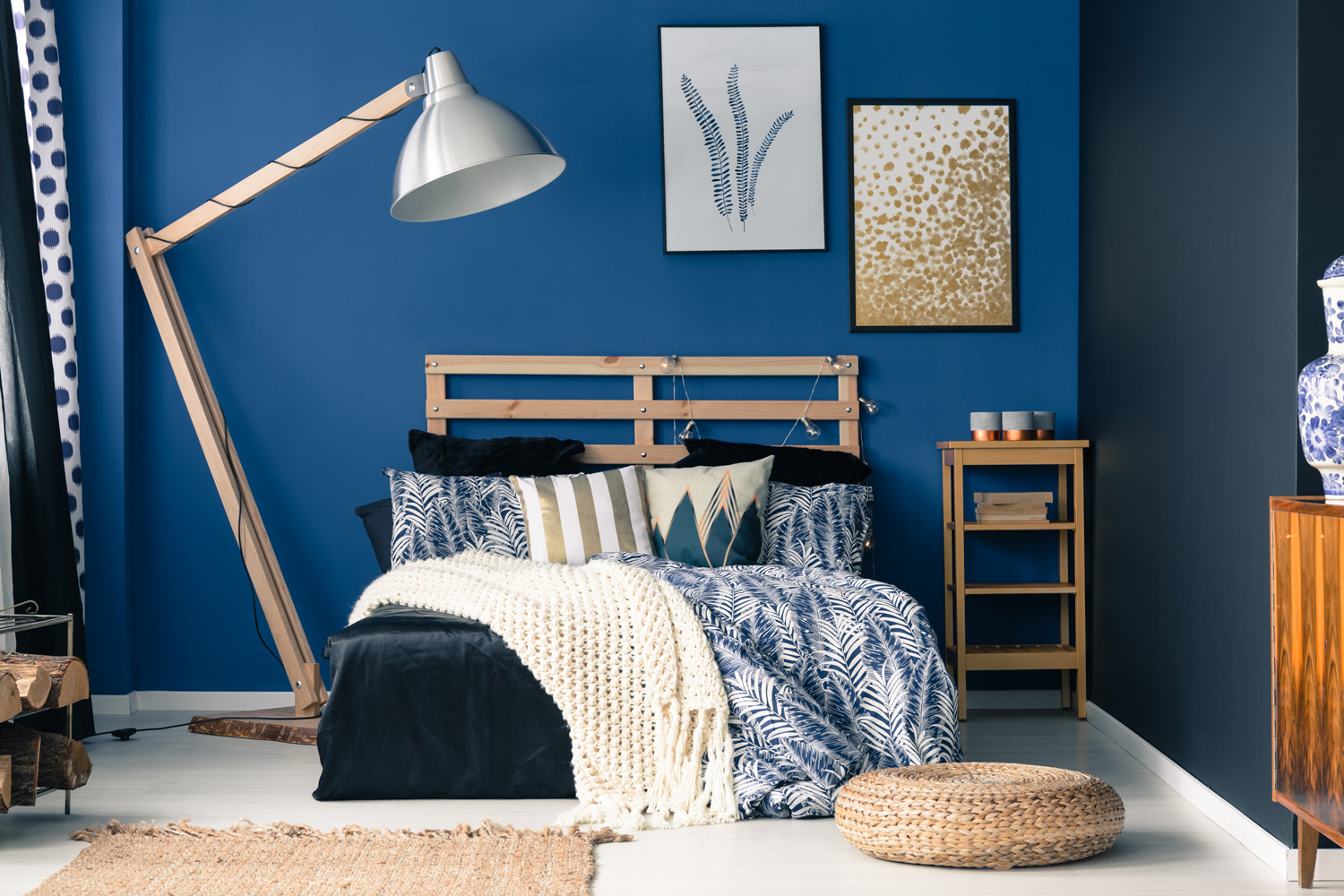 Stylish bedroom interior with dark blue wall