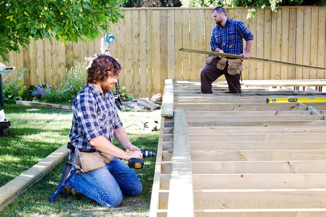 Two men building a deck