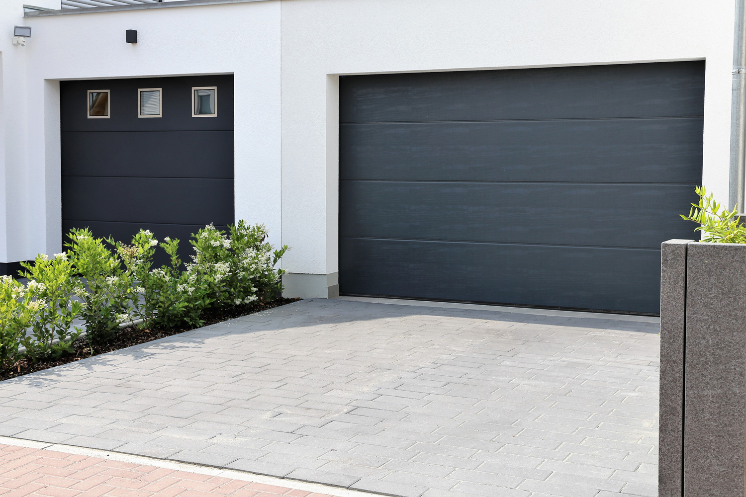 Two modern new garage doors (sectional doors) in a residential district