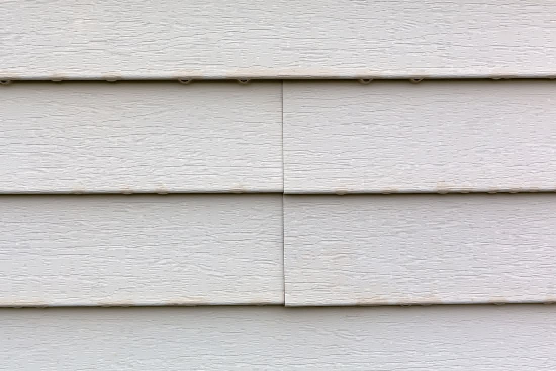 Up close photo of white wooden siding