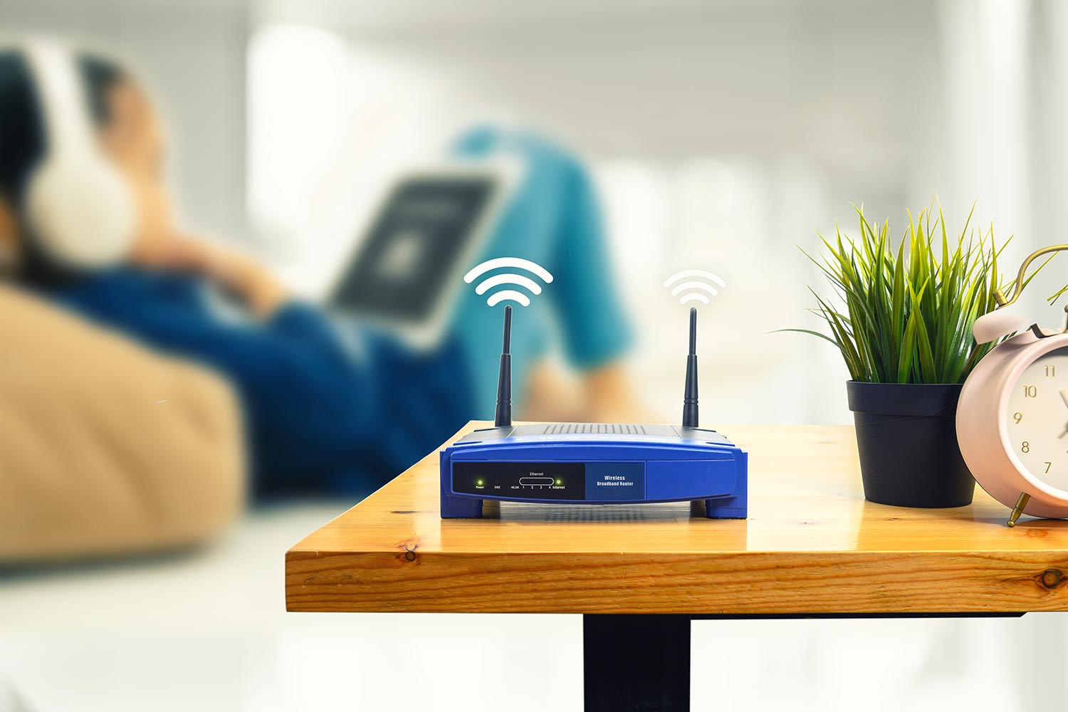 Wireless router and a man using smartphone on living room