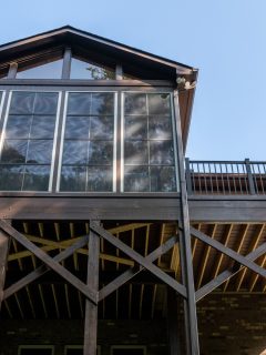 Wooden porch architecture with covered structure with gable roof. Building addition concept - What Deck Height Requires A Railing [Code Requirements]