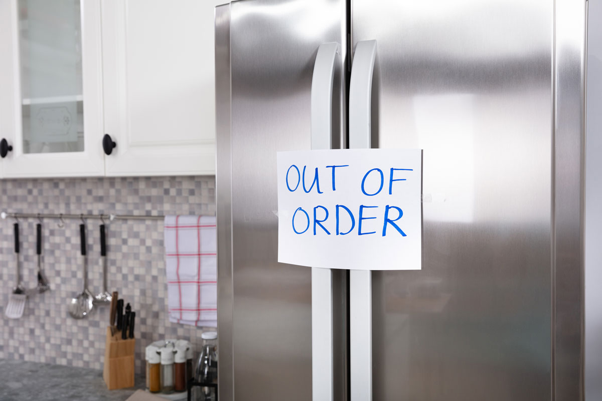 Written Text Out Of Order Message On Paper Over The Stuck Closed Refrigerator In Kitchen