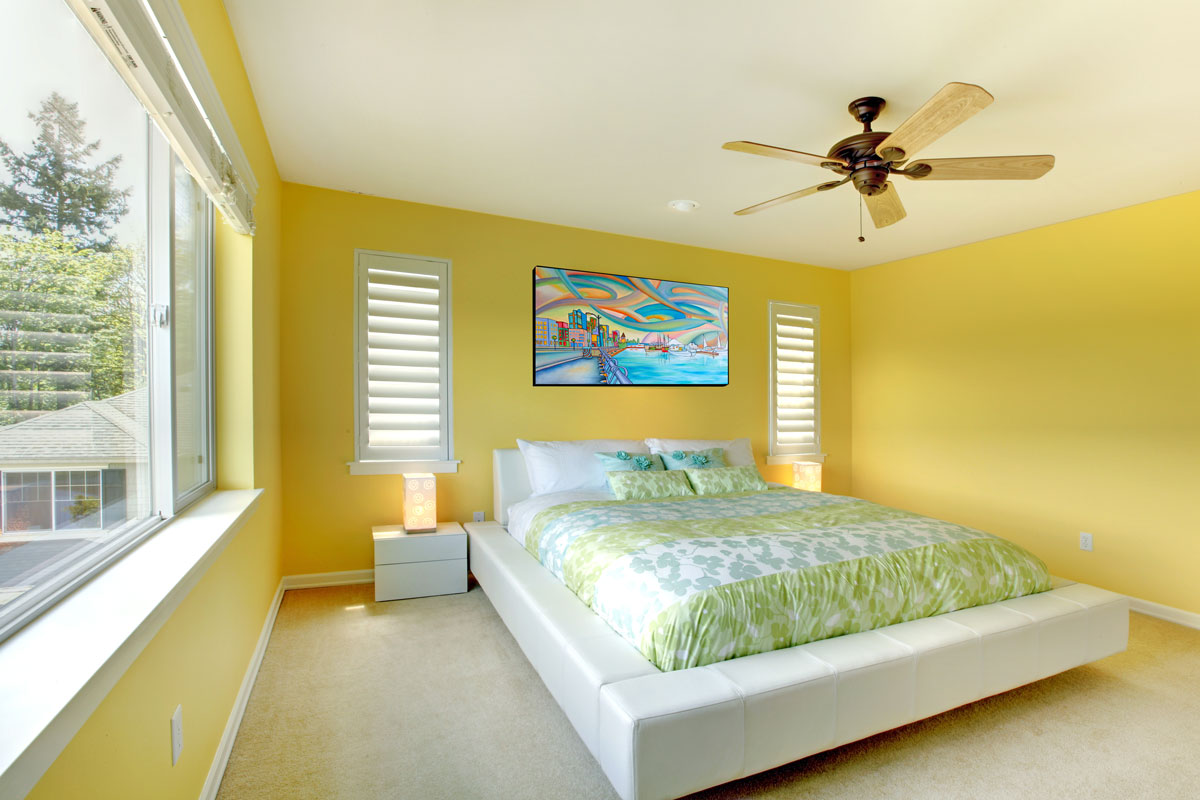 Yellow bright bedroom with green bedding and white bed