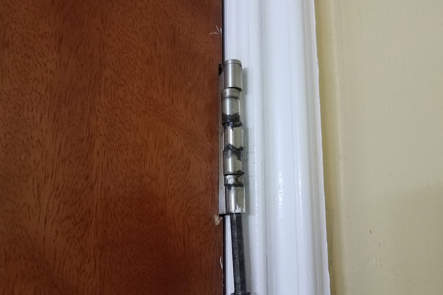 broken or loose metal hinge and bolt on door