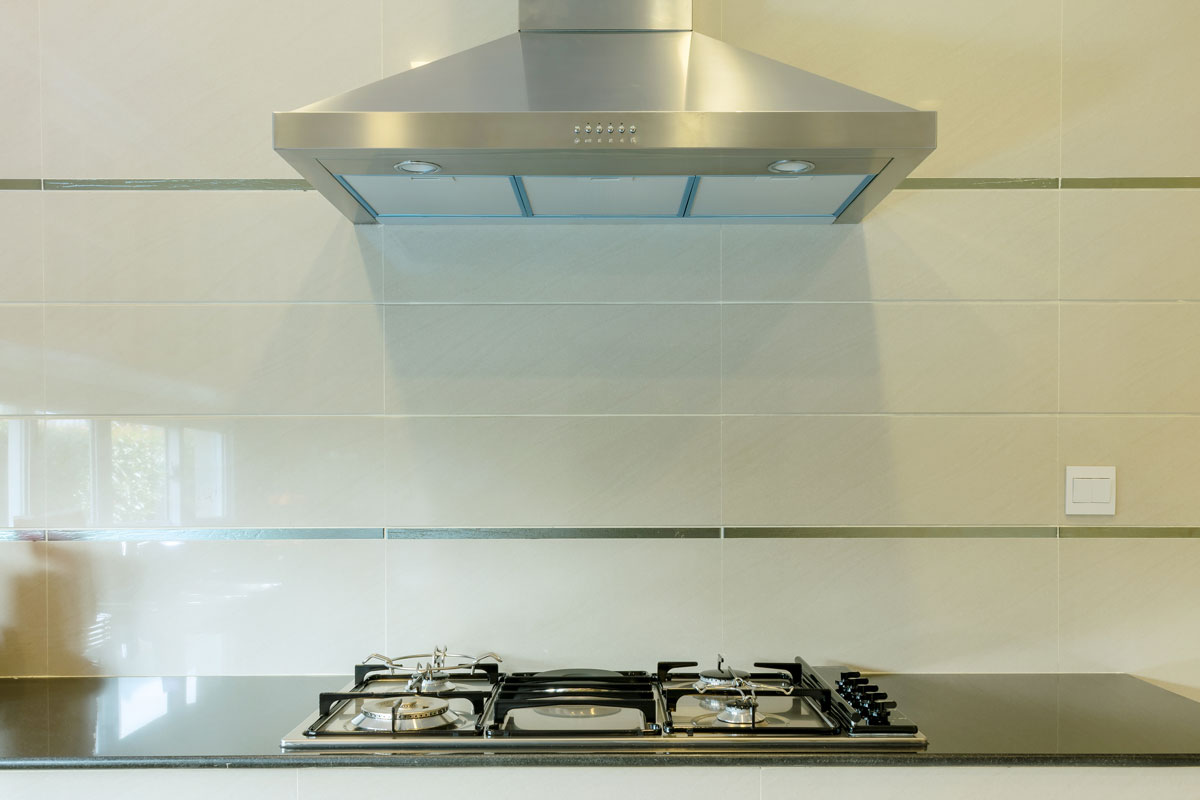 cooking gas stove with hood in modern kitchen