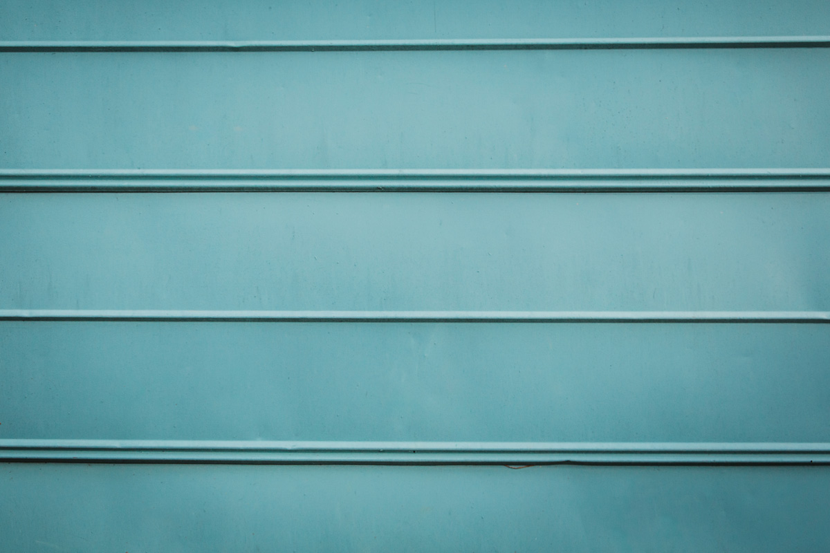 turquoise teal aqua rustic metal siding outdoor exterior wall similar to a garage or metal shed building