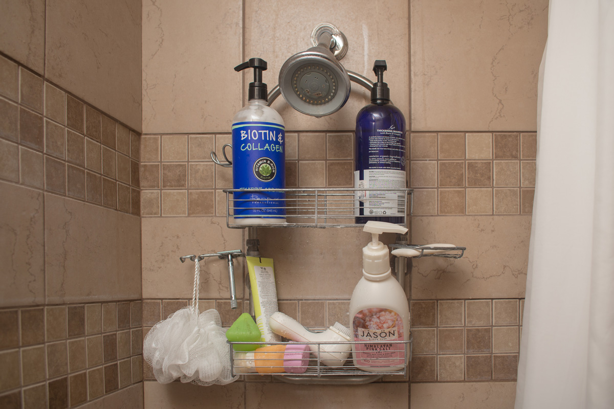 A bathroom shower caddy that hangs off a shower head. Holds a variety of hair care products, soaps, and shaving supplies.