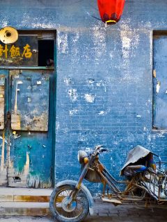A blue door with a blue wall with motorcycle outside, How To Repair A Rotted Door Bottom And Weatherstrip